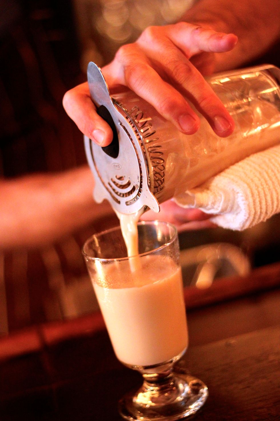 Strain through a hawthorne strainer into a chilled sour glass.