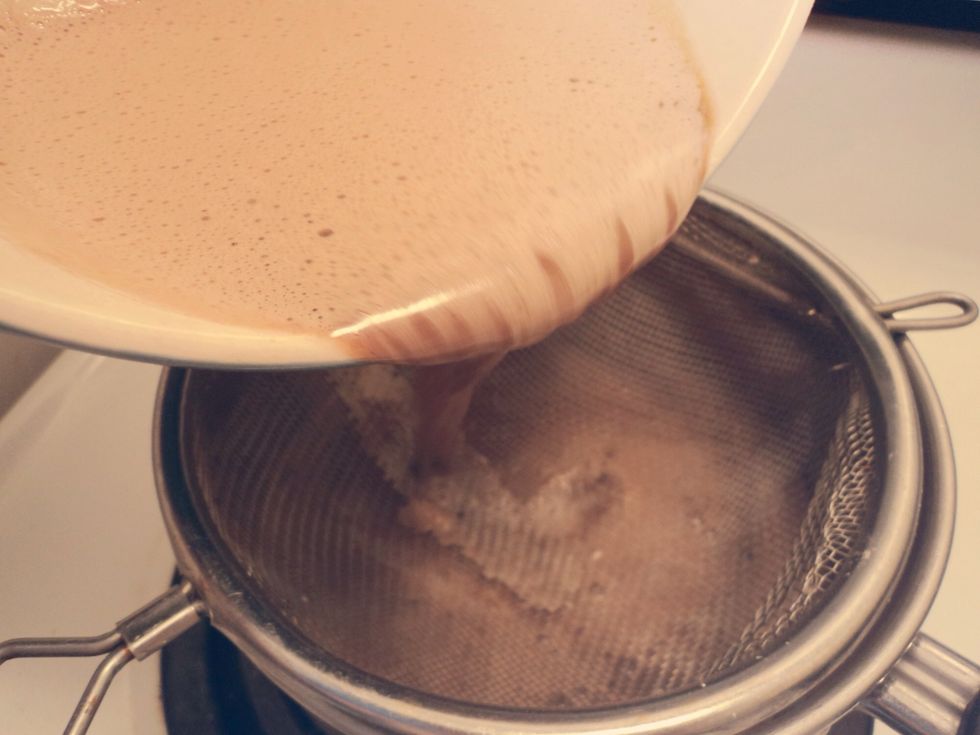 Strain through a mesh strainer and heat in a pot over the stove.