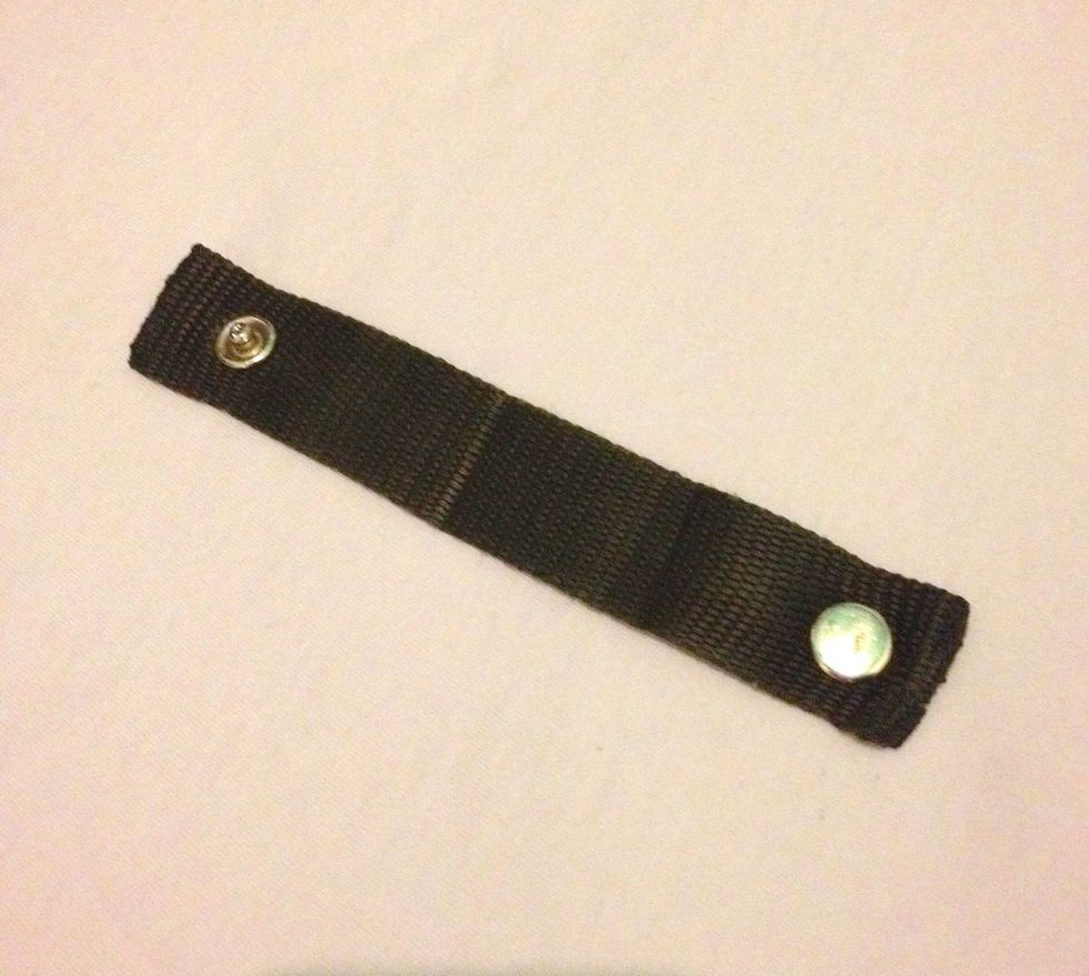 Strap shown with both press studs attached.