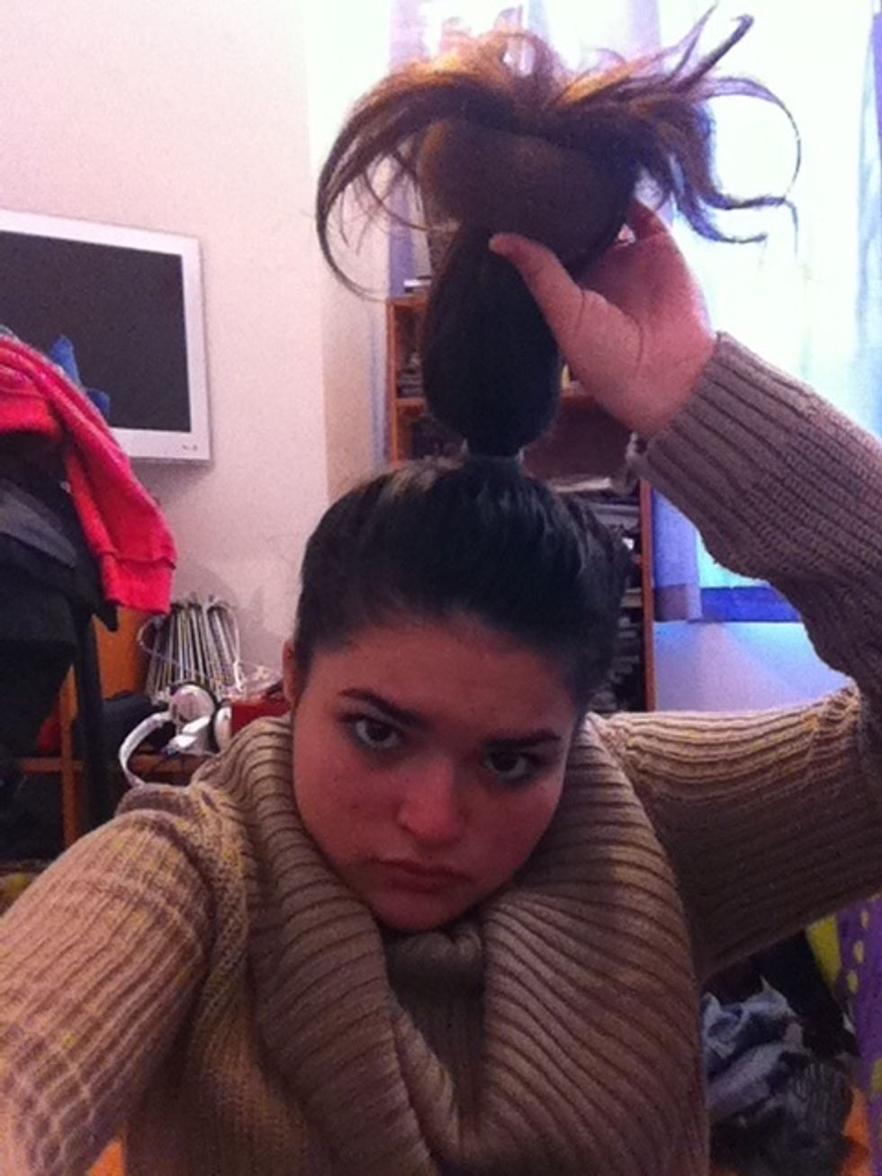 Strech your hair and put the donut on the end of your hair