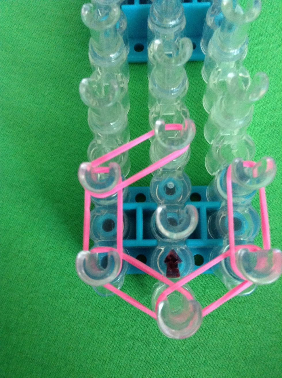 Stretch a rubber band from the left side to the center. Do the same on the other side