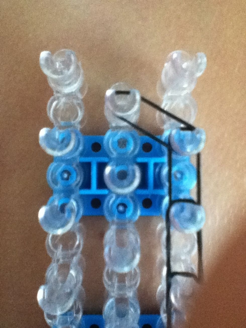 Stretch another rubber band from the second to last peg to the last middle peg