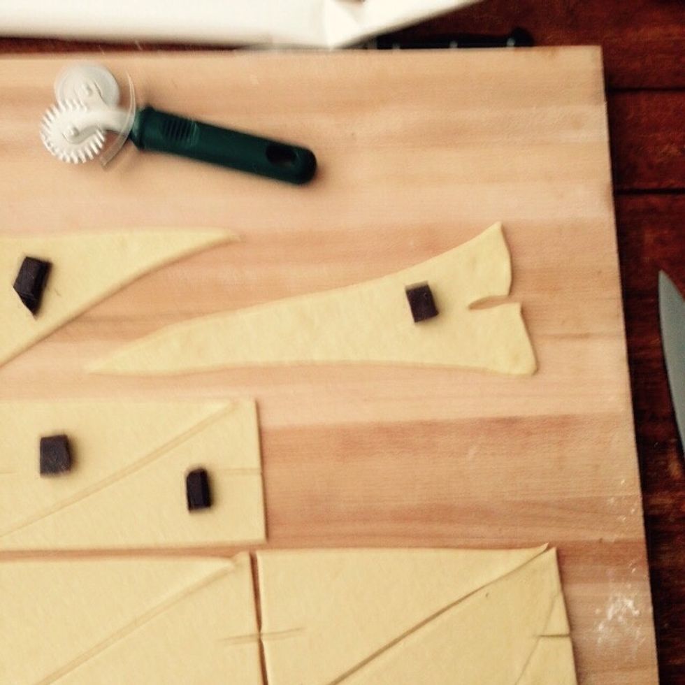 Stretch each triangle with your hands gently to almost double the length. Be careful to do not rip it.