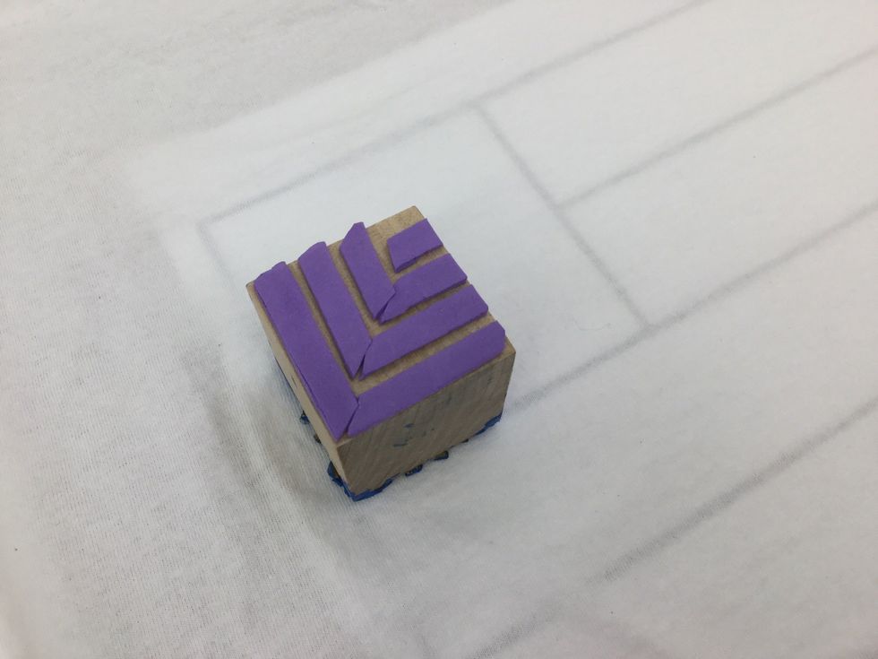 Stretch t-shirt over a piece of cardboard, then slide template into place. Use it to guide the placement of your stamp prints. You can download a pdf copy of the template here: https://goo.gl/saViCj