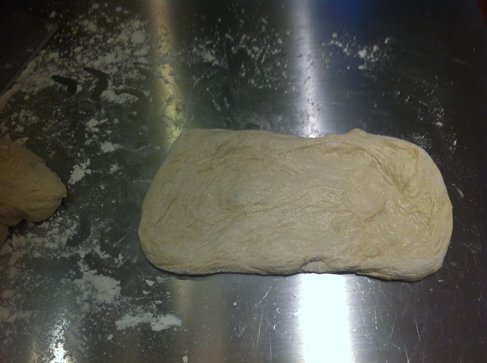 Stretch the dough into a rectangle. Try to avoid breaking the bubbles.