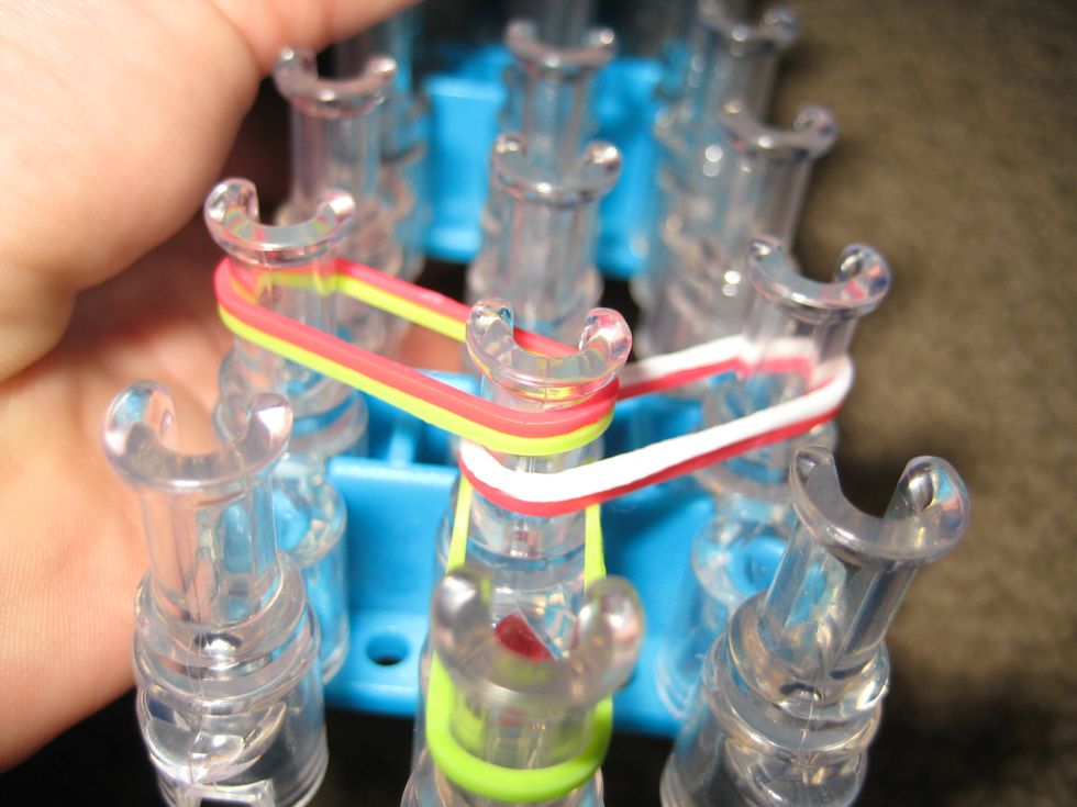 Stretch two bands across to the pin diagonal. Double the bands. Also, do the right side first.