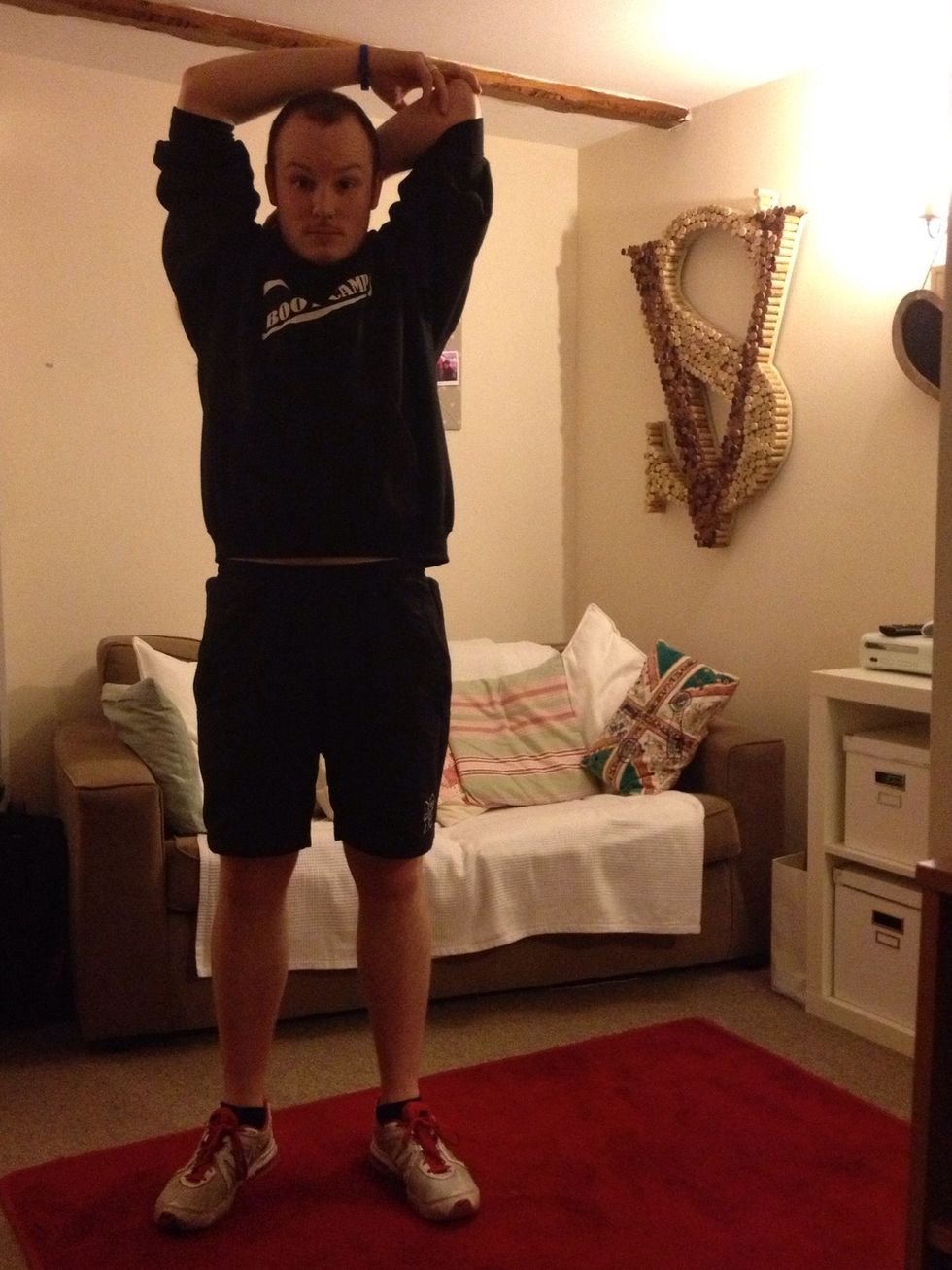 Stretch your arm behind your back holding it at the elbow with the other arm