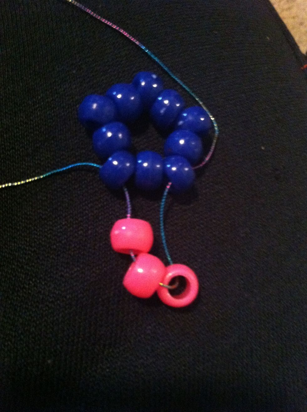 String 3 point beads onto the cord and string the cord into the 3 bead while ignoring the bead in the middle of the base
