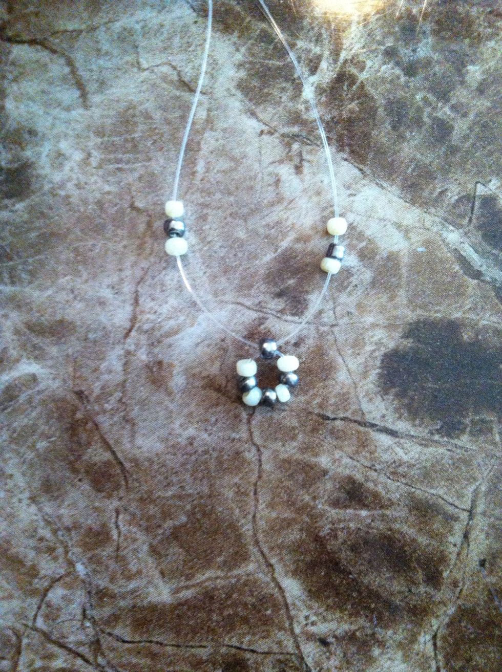 String a white, silver, and white bead on each side