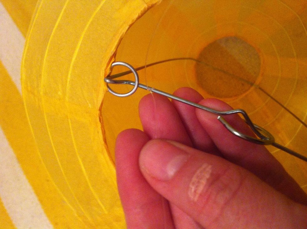 String all of the lanterns using fishing line. Use about a foot of line so you can hang some longer. It's better to have too much line and trim it after.