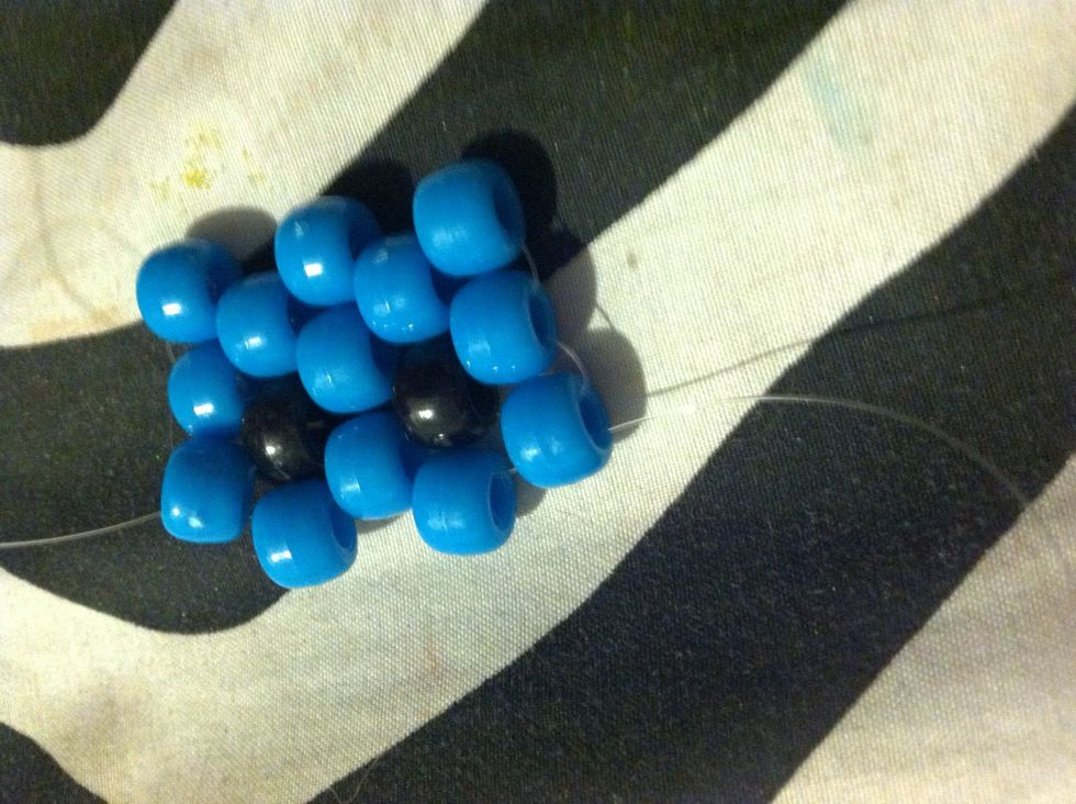 String And String It Through The Opposite Way And Pull It Tight . After That string Through The Next Top Blue Bead And Add Two More Beads Like You Have Been Doing .