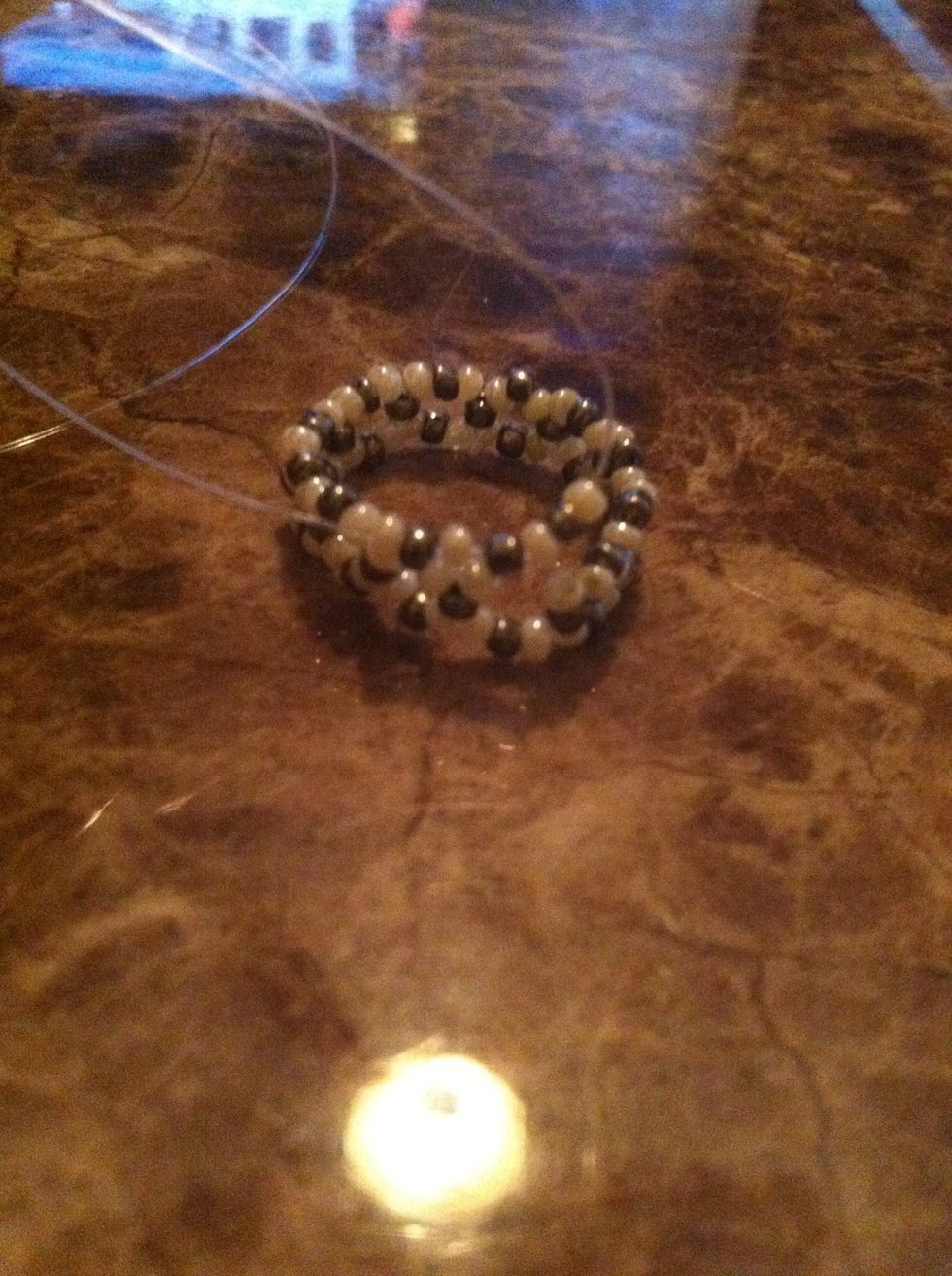 String another white bead on the left cord and a white, silver, and white bead on the right end