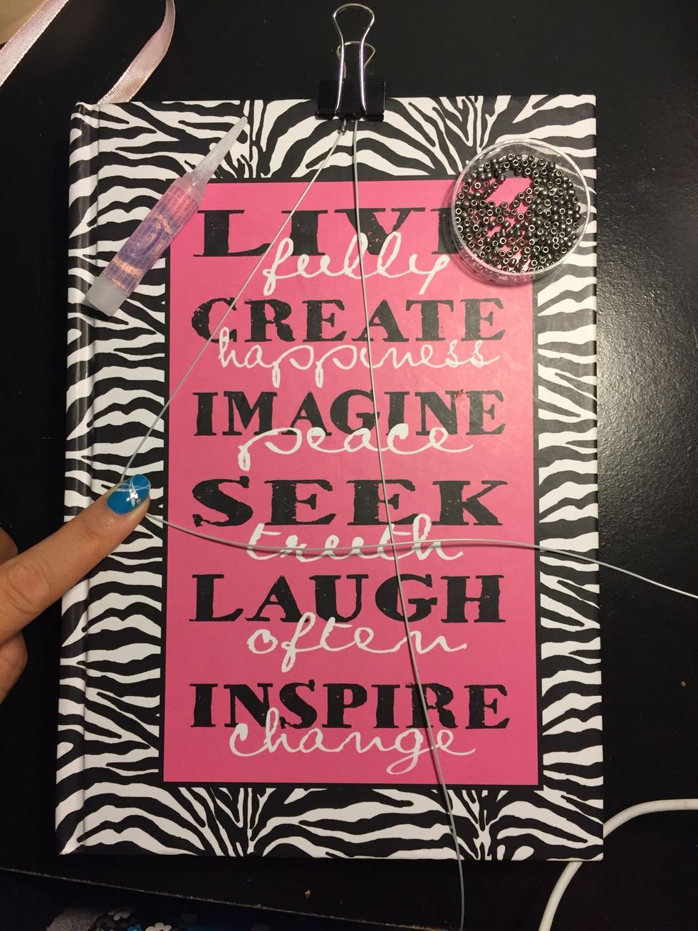 String on a bead on the left string.Make a 4 shape with your left string over the right