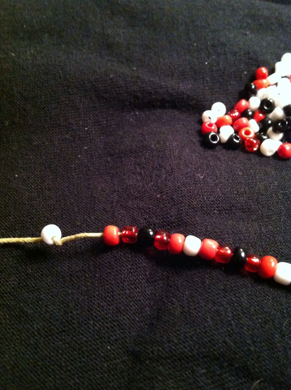 String on your beads, on one strand in any pattern you like... Or no pattern at all. Tie a bead to the end to keep them from falling off. You can add beads to both strands to create a different effect