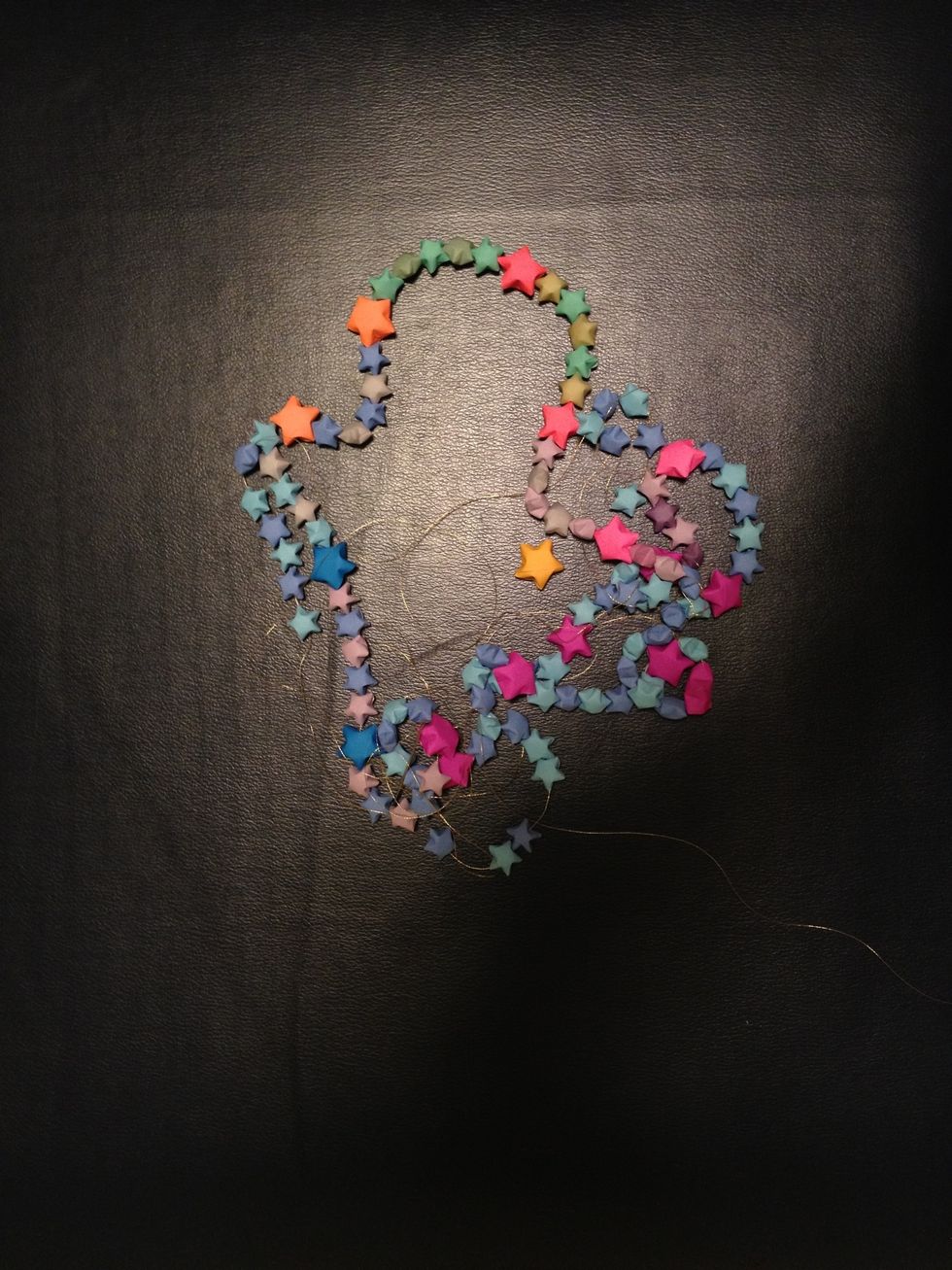 String them into a necklace! Be creative! There is a lot of things you can do with this! For example I made a design on my wall with about 75 stars.