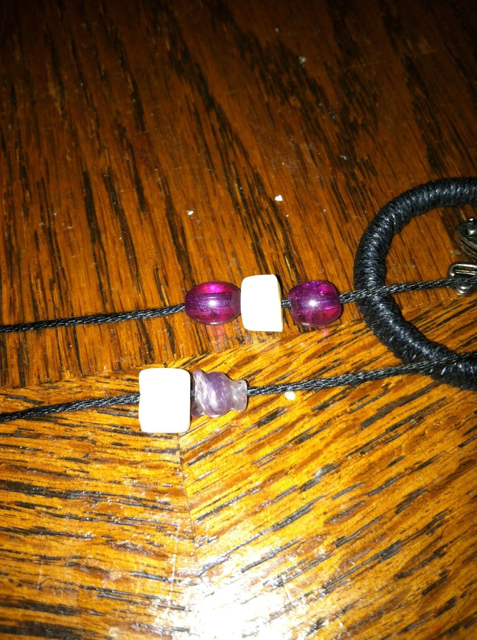 String you beads or other charms. Remember that they will hang in the back. If you want them to hang in the front you will have to reverse your center charm when you attach it.