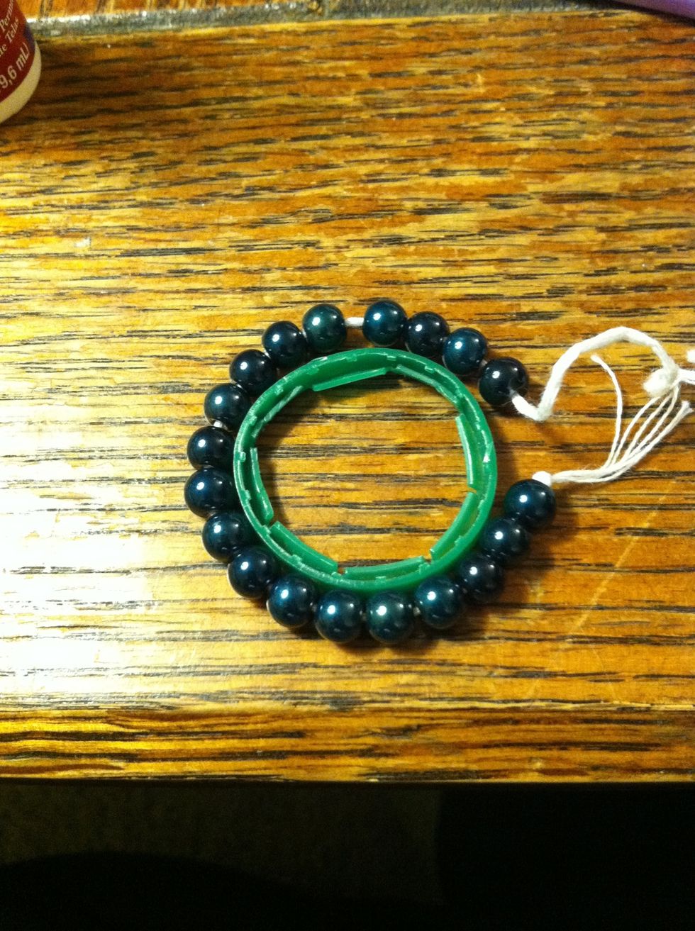 String your beads. I premeasured so even though it looks short I know it'll fit. Better to add more beads then not enough because it'll be much easier to remove them later than it will be to add them.