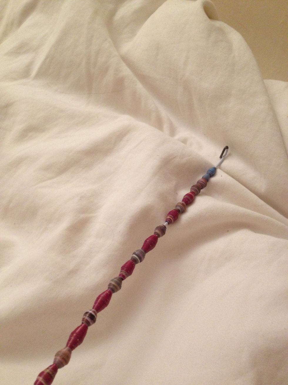 String your beads on the hanger. Hook the end. This is the easiest way I could figure to prepare the beads for the next step. (These are some other beads I've done)