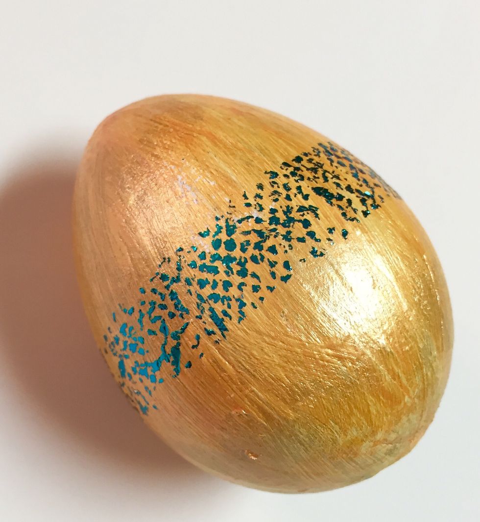 stripe added to center of egg. repeat steps at either end of egg to add 2 more stripes.