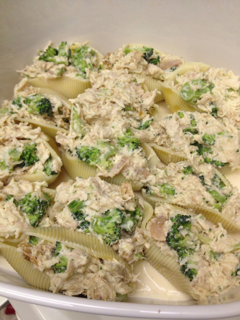 Stuff shells and place into pan.