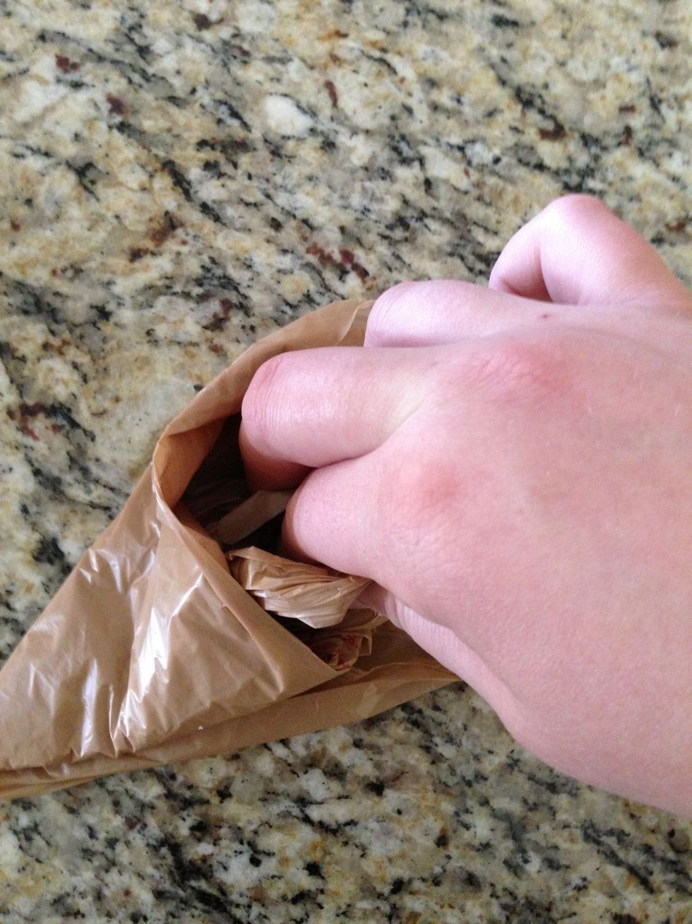 Stuff the bag handles into the first pocket opening inside the triangle.