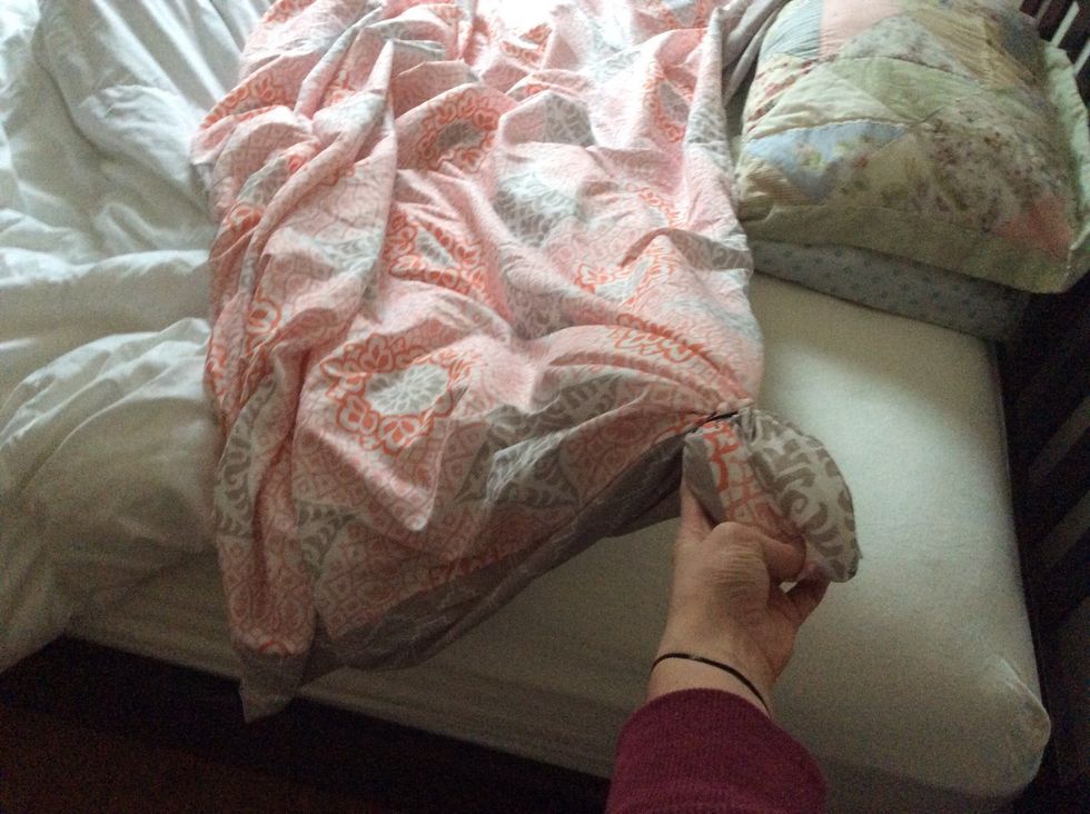 Stuff the blanket in the duvet cover all the way to the head board corner, and add a hair tie to hold it together