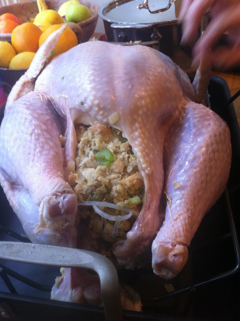 Stuff the cavity of the bird with as much of the remaining stuffing as you can, until it forms a delicious mound.