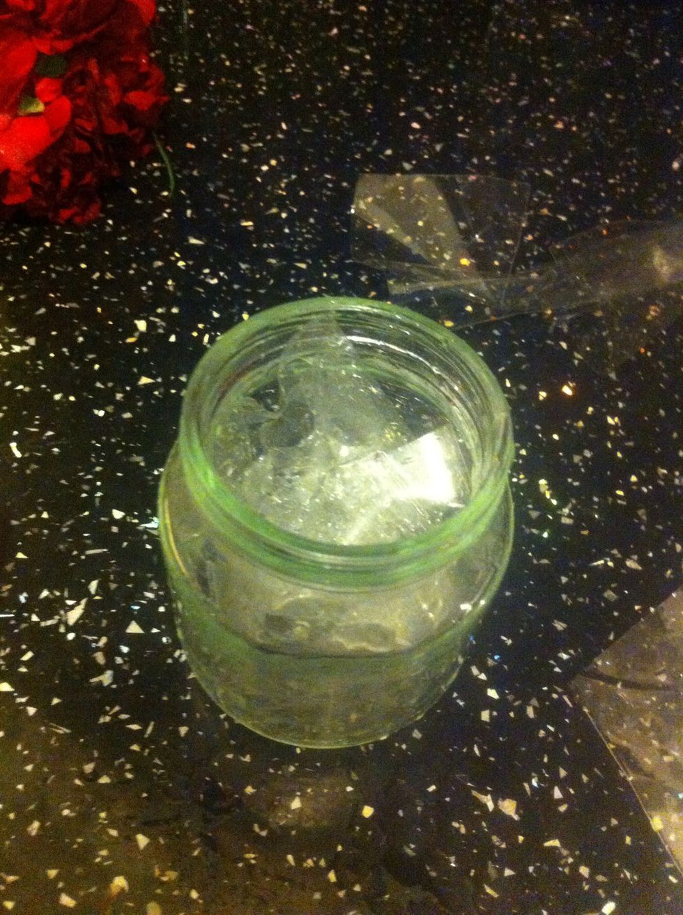 Stuff the plastic wrap into the jar, leaving just enough to stuff the flowers into!