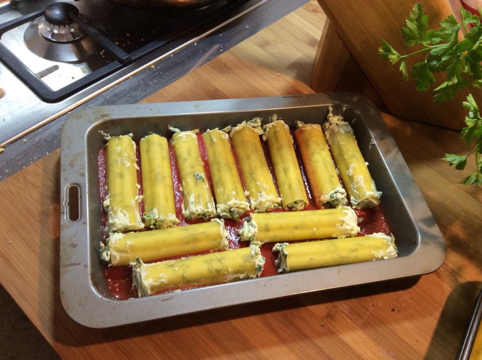 Stuff your mixture into 12 tubes of cannelloni, I recommend using a piping bag but if you don't have one, like me, use a spatula or your hands.