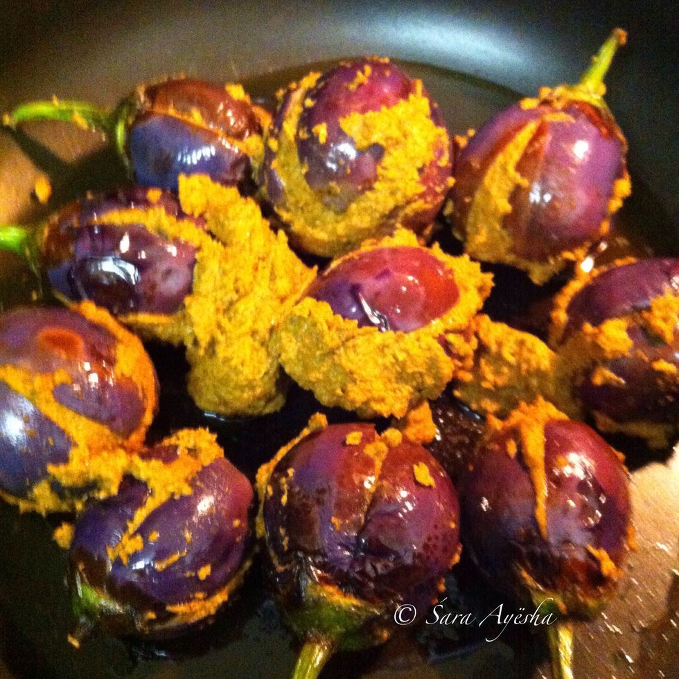 Stuffed it into the fried eggplants by slightly opening the slit without ripping apart. Tried taking video but was not fruitful. And arranged them in a pan with little olive oil.dump the extra paste.