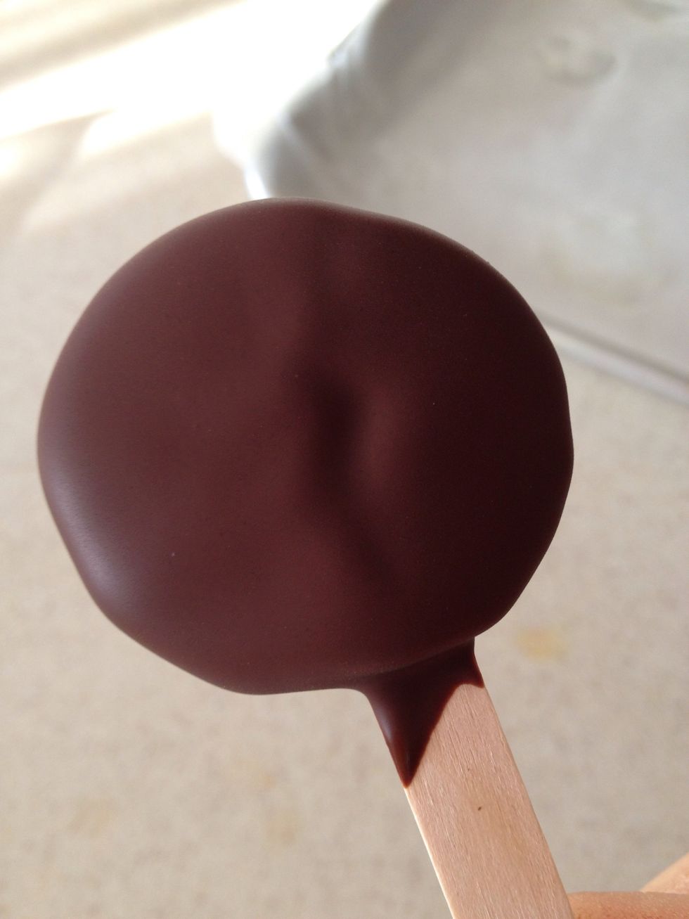 Submerge it past the kiwi and to the stick. This prevents the kiwi pop from falling apart.