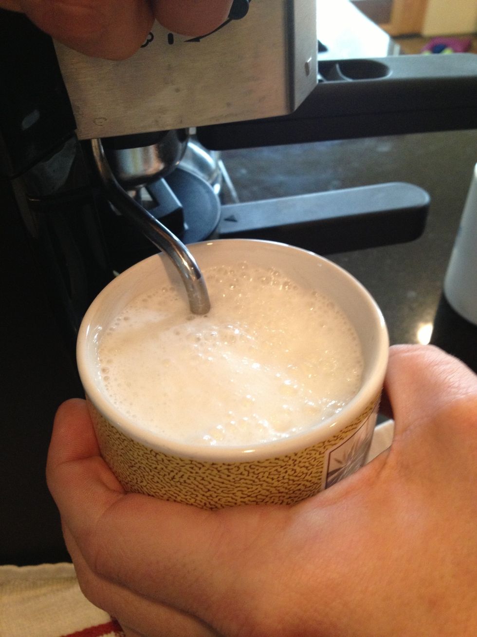 Submerge spout to heat up milk