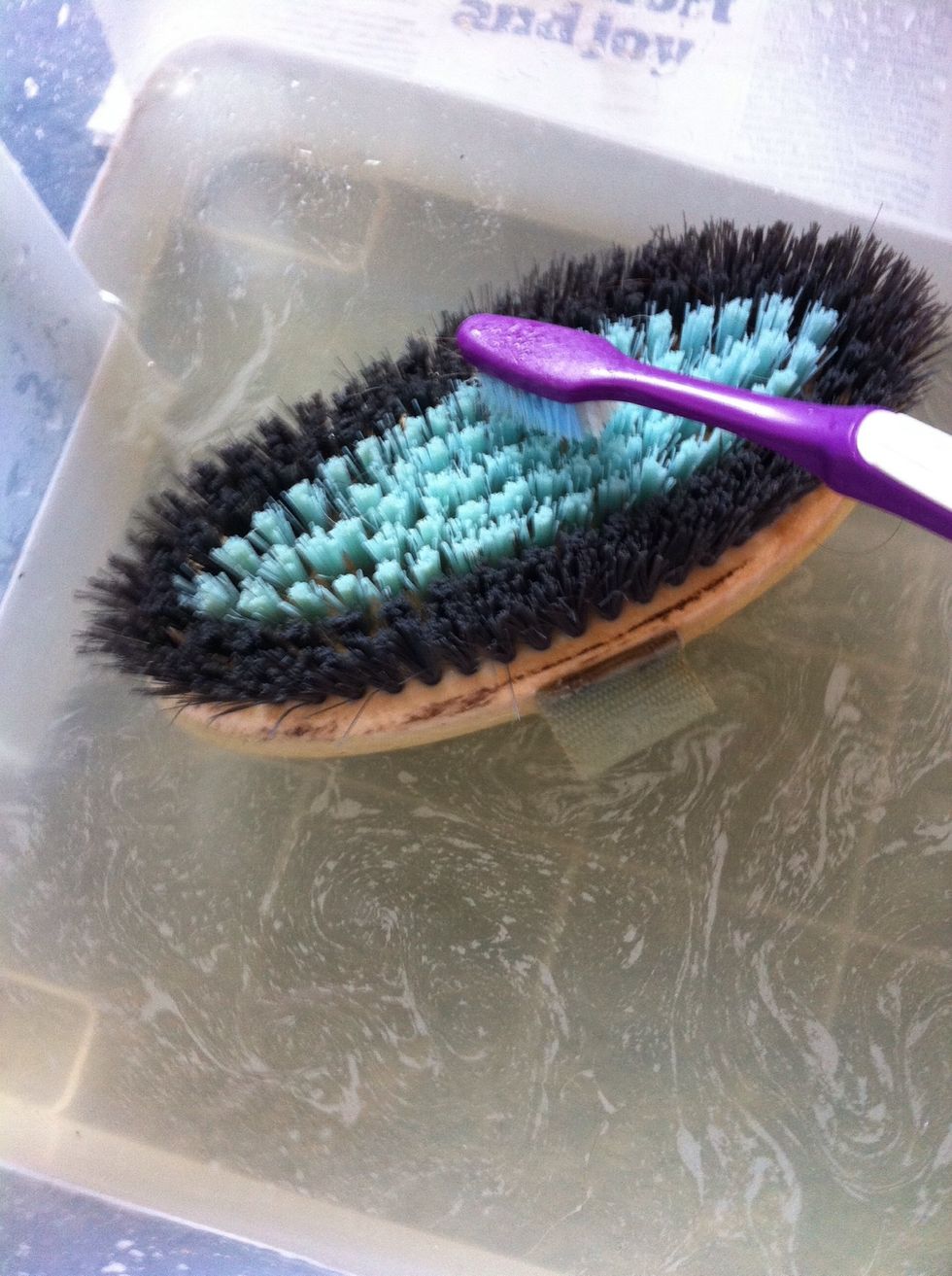 Submerge your brush in the water now and push the toothbrush right into the bristles. You want to clean the muck off the 'board' right at the bottom of them, so be firm