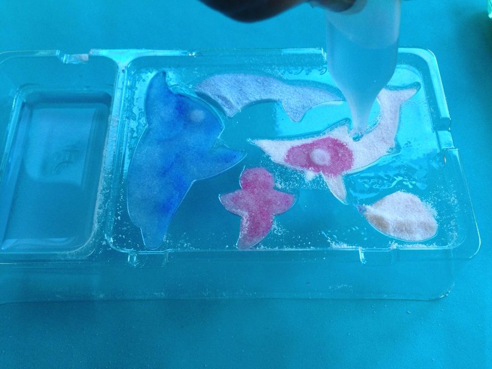 Suck up water/activator mix and slowly squeeze one drop at a time into all of your powder molds. After they look soaked, pick up tray to see if soaked on bottom too. Wait 3 Minutes. Do not touch yet!