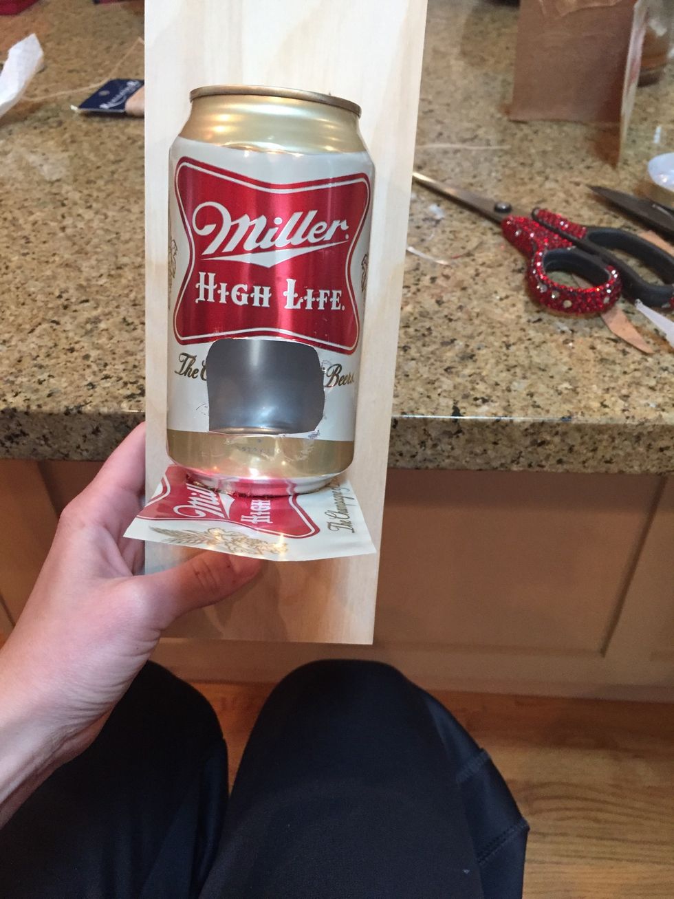 Super glue the strip from the second can to the bottom of the first can. Leave enough room for the bird to sit on it