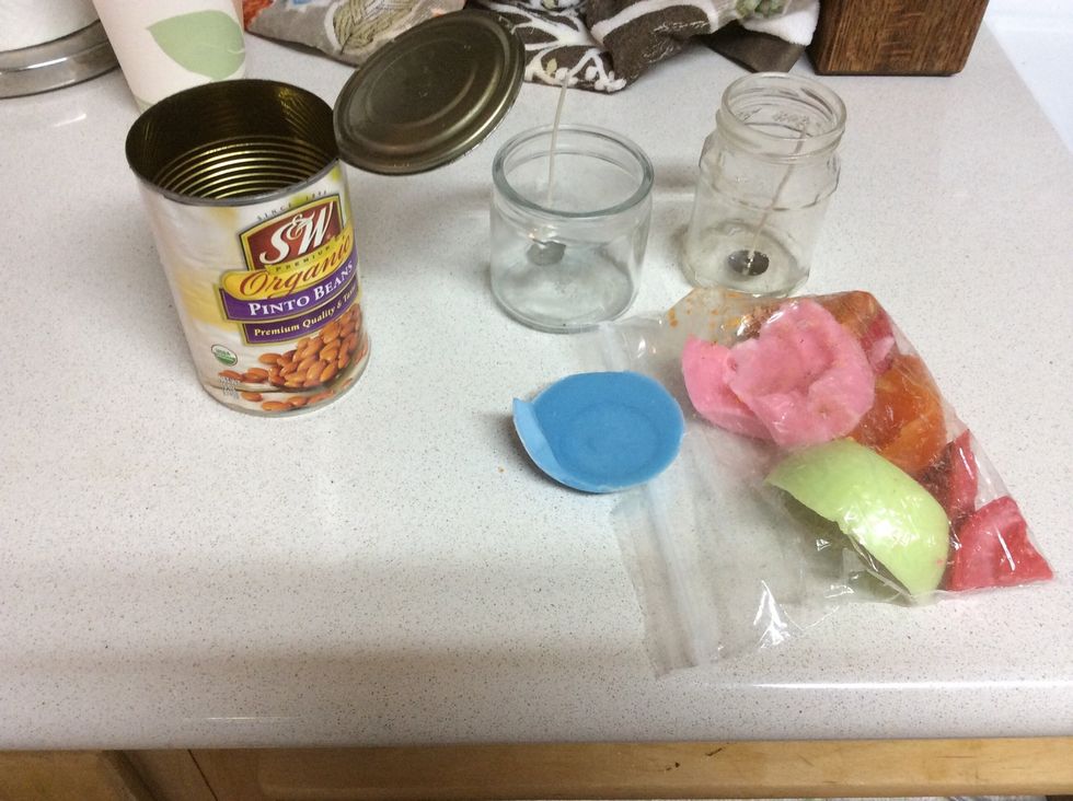 Supplies prepared- old wax, tin can for "double boiler," and two glass candle jars with new wicks placed inside. You can trim wicks after pouring all your wax.