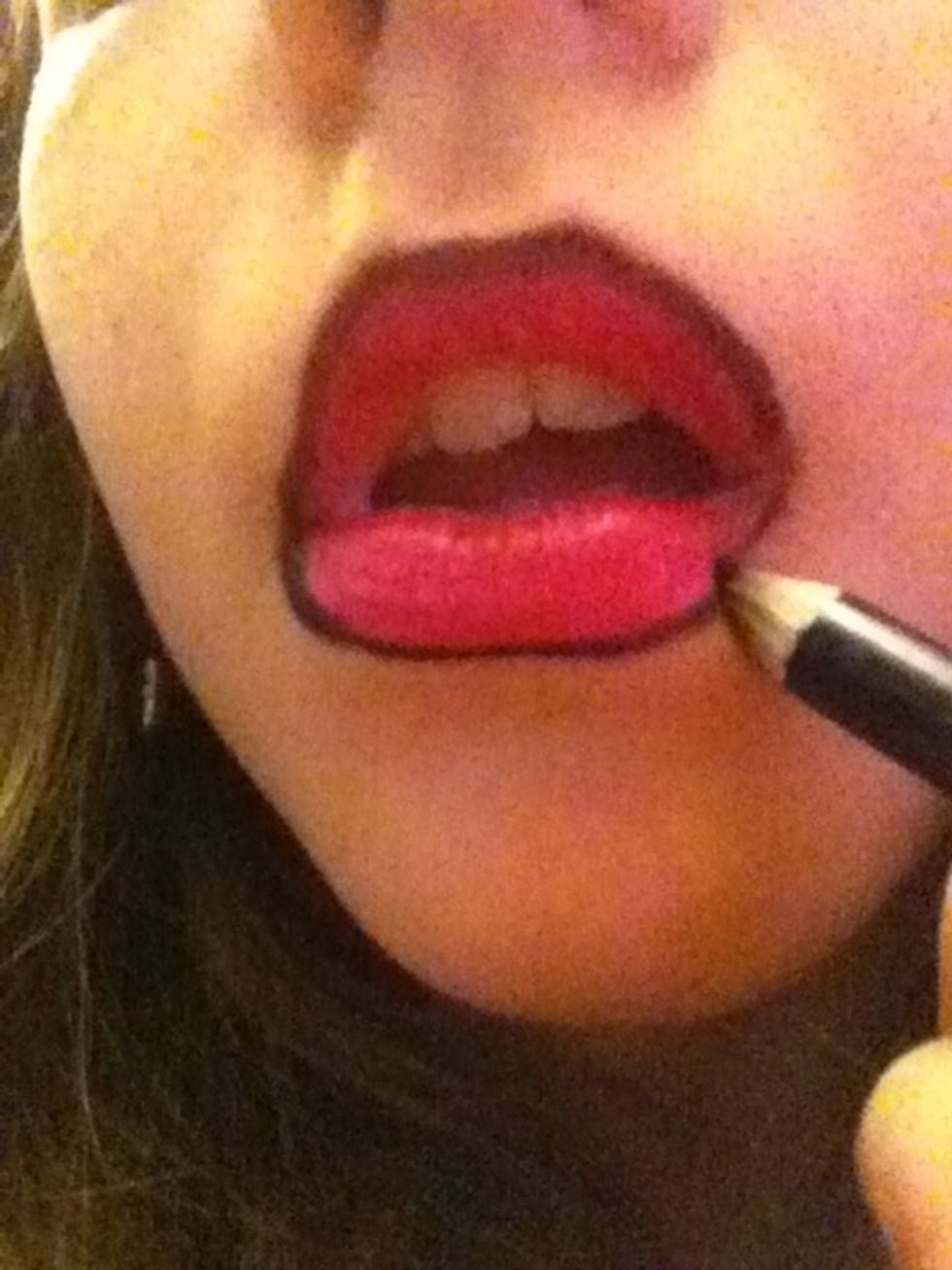 Surround lips with black eye liner or black lip liner