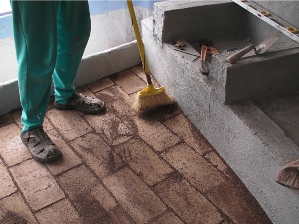 Sweep fine sand into the cracks between bricks. Let it settle, then repeat. For a longer lasting floor, use concrete mortar in between each brick as you lay it. This is harder, but is more durable.