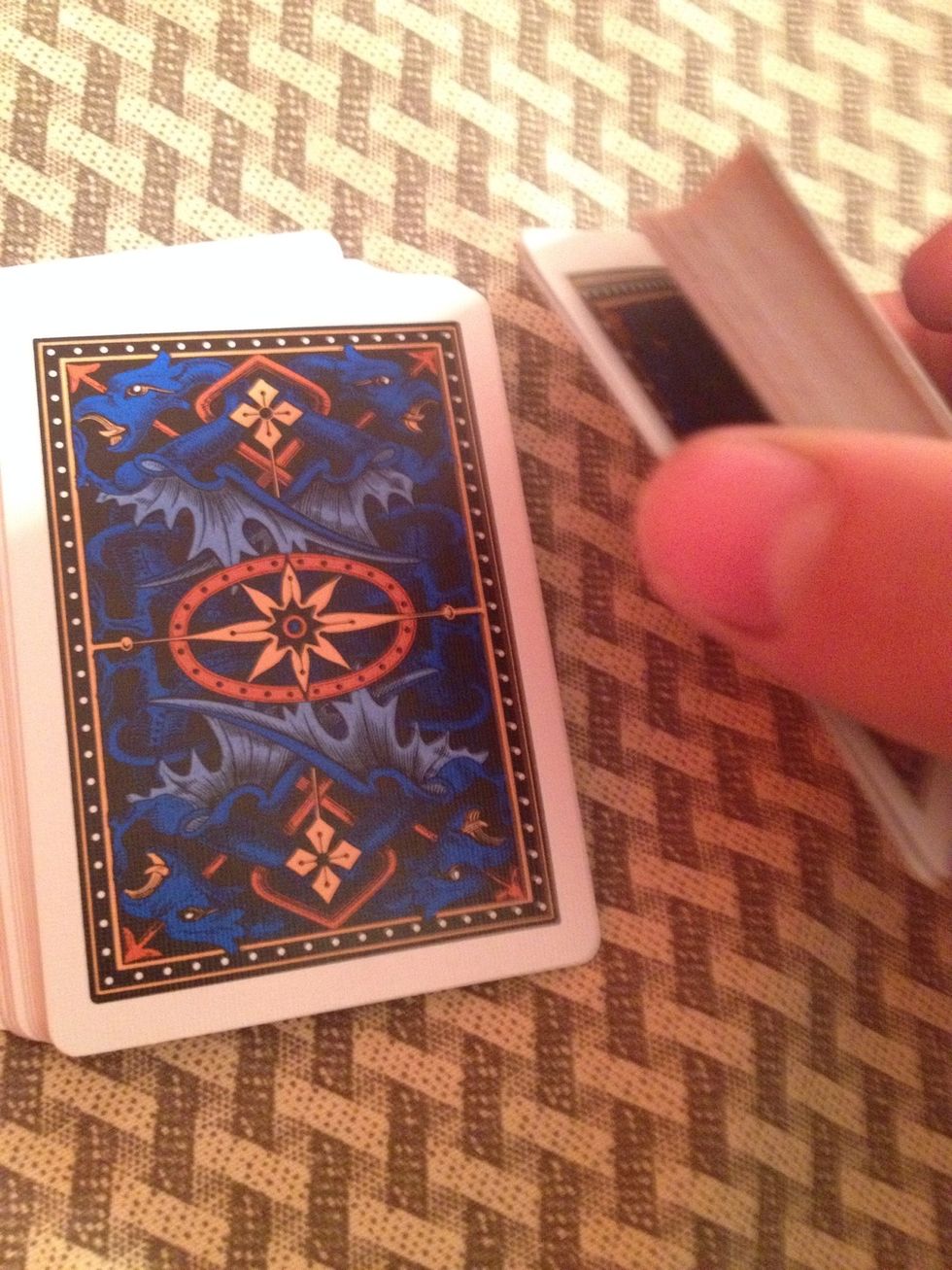 Swing cut the top half of the cards off while keeping the pinky break.