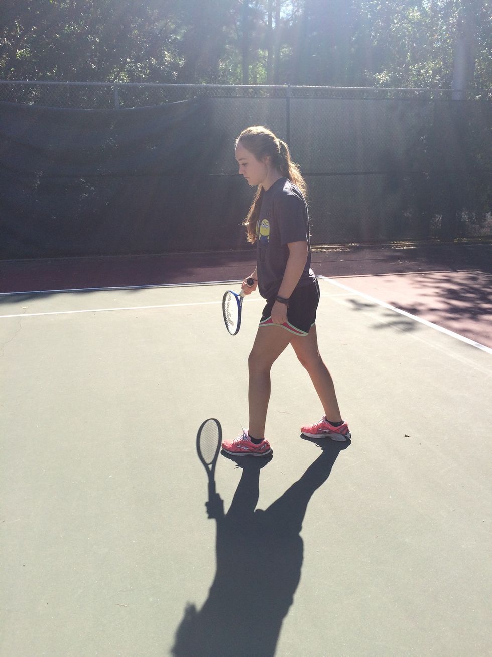 Swing racket down and in front while keeping an eye on the ball.