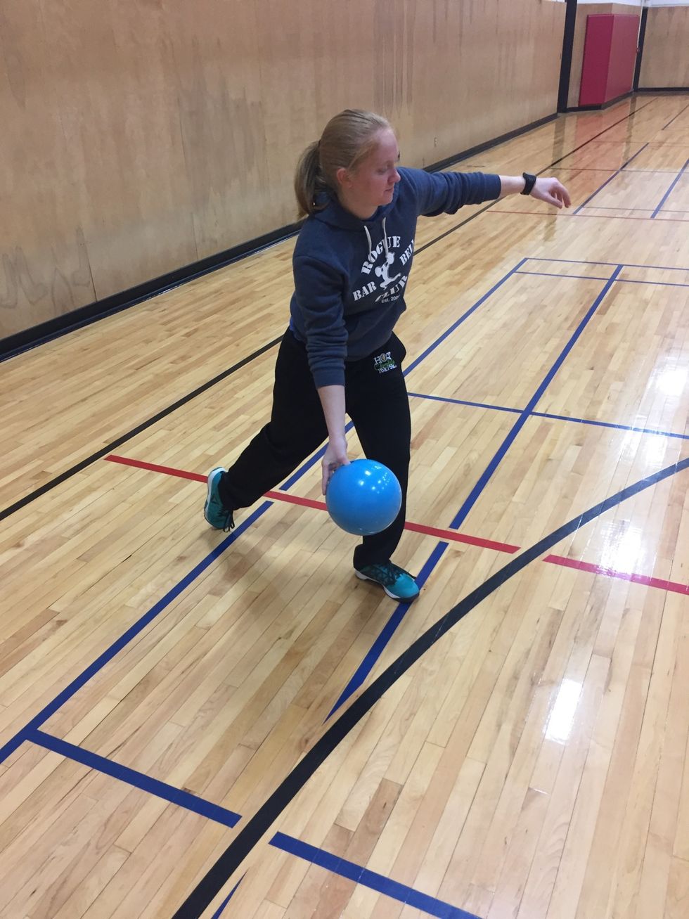 Swing the ball through, keeping weight on the front foot