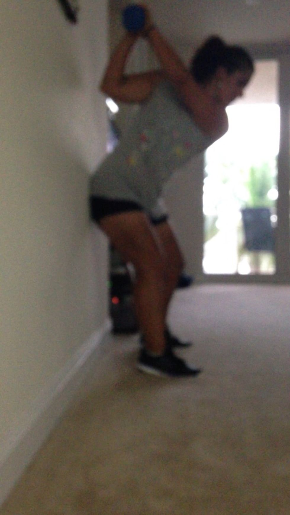 Swing the weight like a club keeping your but against the wall