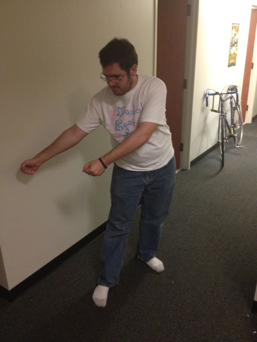 Swing your arms to the left, keeping both arms in front of your body. At the same time, swing your hips to the right. You are now back at the starting point.
