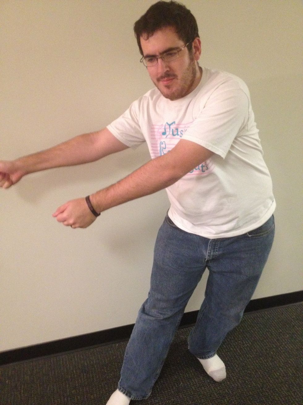 Swing your arms to your left, back to your initial position. At the same time, swing your hips to the right. Step 2 and Step 4 should look identical.