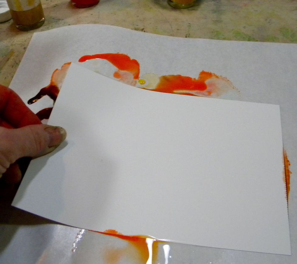 Swipe the paper through the inks.