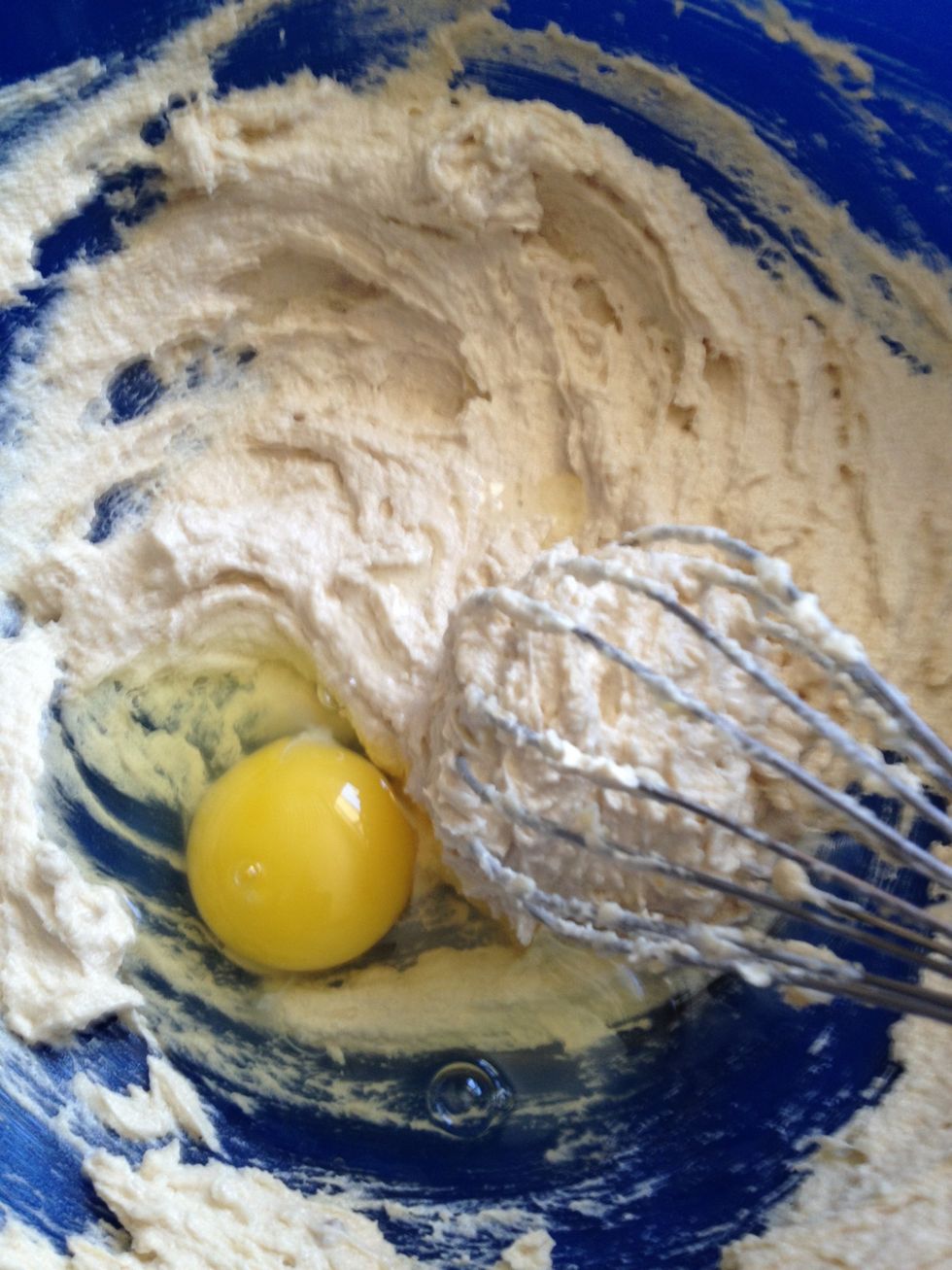 Switch to a whisk and add 1 egg. Fully incorporate egg into mixture before adding 2nd egg