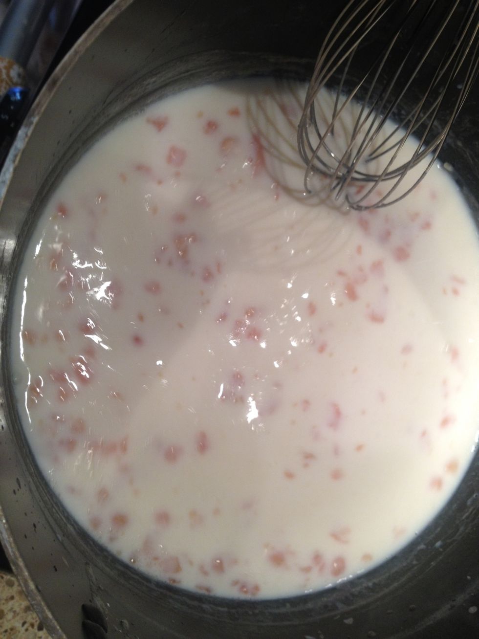 Switch to a whisk and pour in milk. Whisk constantly and bring to a boil. Reduce heat and simmer until thickened. You'll know it is done when you can coat the back of a spoon with the sauce.