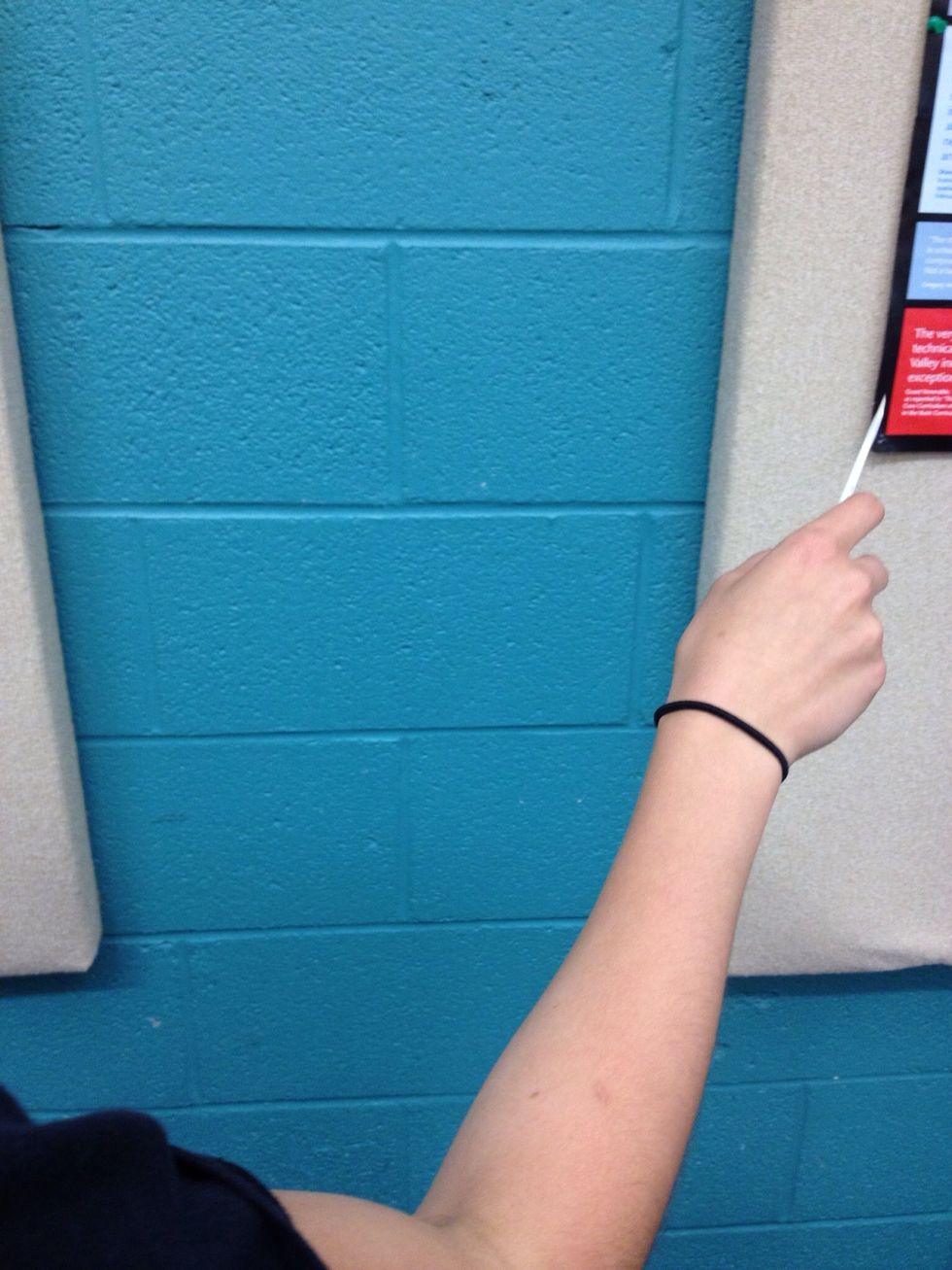 Swoop your hand to the right, again with a fluid motion.