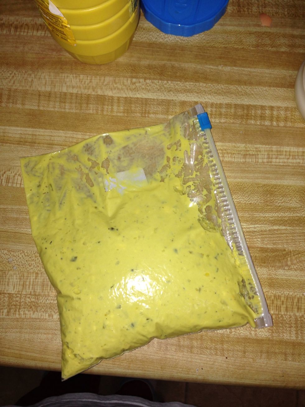 Ta Da! Now push all of the yolk mixture down to one of the bottom corners and snip off that corner. Don't squeeze yet. It will go everywhere :).