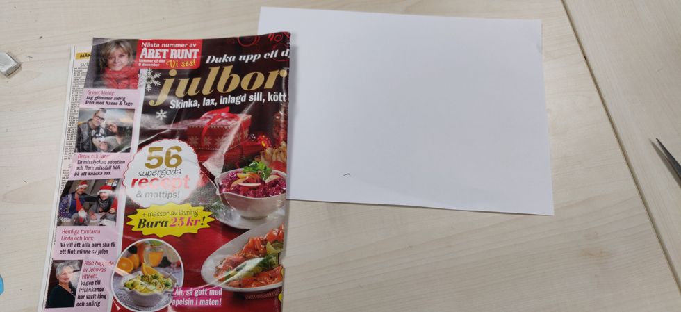 Ta en tidning och ett vitt papper.
